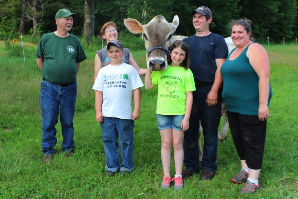 The Smith family of More Acres Farm in East Dixfield with the herd favorite and eldest milk cow - a Brown Swiss named Revlon. Pictured from left are Les, Judy, MJ, Amber, Matt and Stephanie.