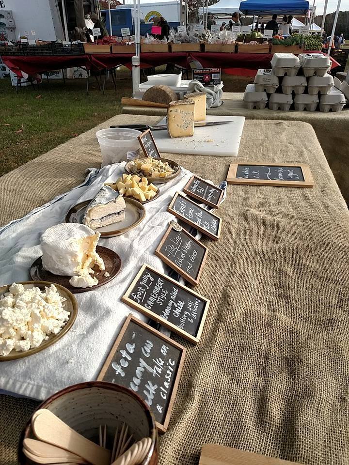 Some of Winter Hill's lineup of cheeses at a farmer's market. Photo from Winter Hill Farm Facebook page.