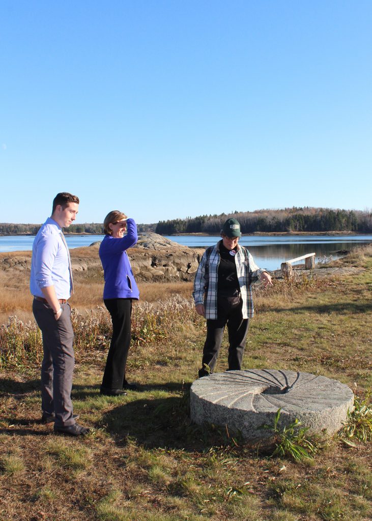 Dietetic intern Zakk Castonguay, MDNC School Programs Manager Katie Hoffmann and farmer get a tour and learn about the history of the farm, which started with the grist mill. One of the grist stones is still there.