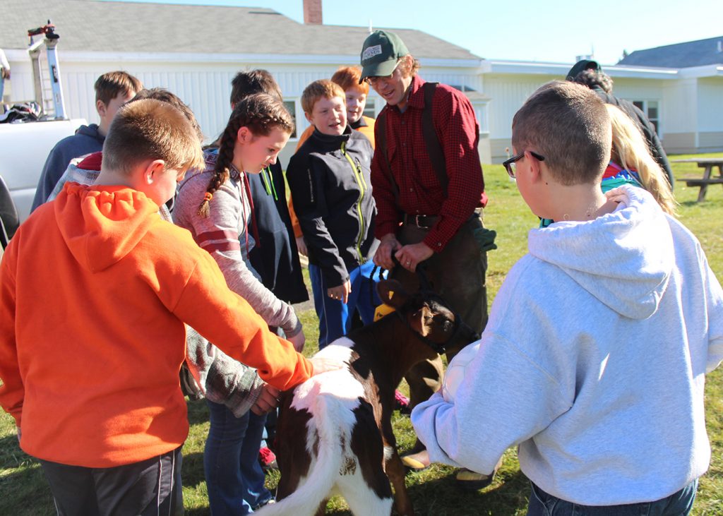 Aaron Bell introduces students to his farm's future milk cow.